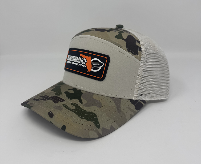 Camouflage baseball cap with a brand patch on a white background