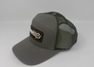 Gray mesh cap with a logo patch on a light gray background